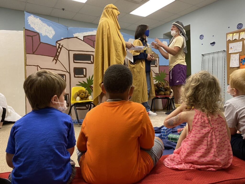 Children watch members of the youth group perform a skit during Sonrise Saturday.